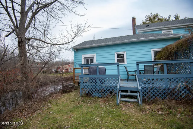 a view of a chairs and table in the backyard