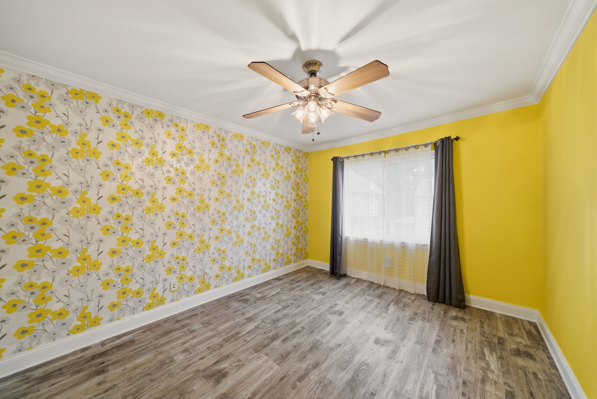 6452 Burgoyne Road, Unit 100 Houston, TX 77057 - Photo 30 of 44 an empty room with wooden floor and a ceiling fan