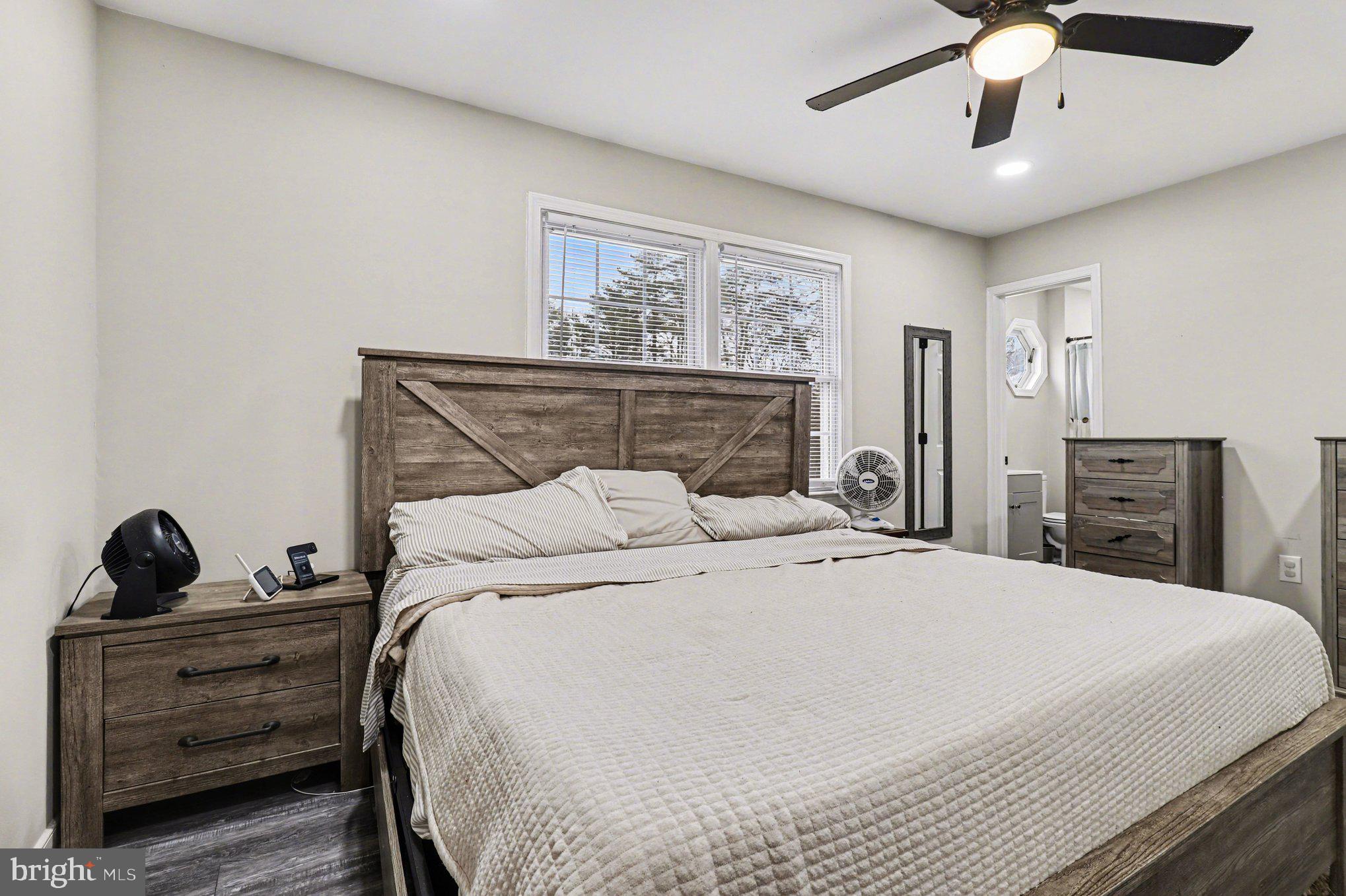 2225 Partlow Road Beaverdam, VA 23015 - Photo 15 of 27 a bedroom with a large bed and a chandelier