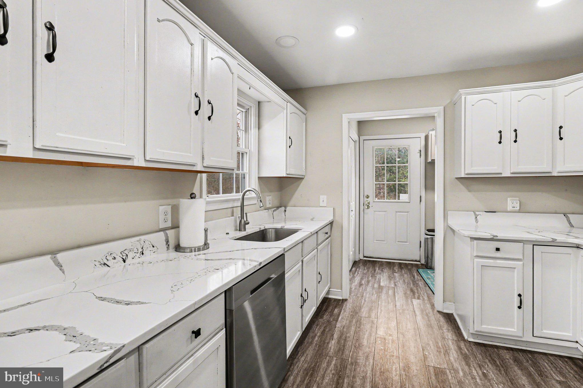 2225 Partlow Road Beaverdam, VA 23015 - Photo 5 of 27 a kitchen with granite countertop a sink a stove and cabinets