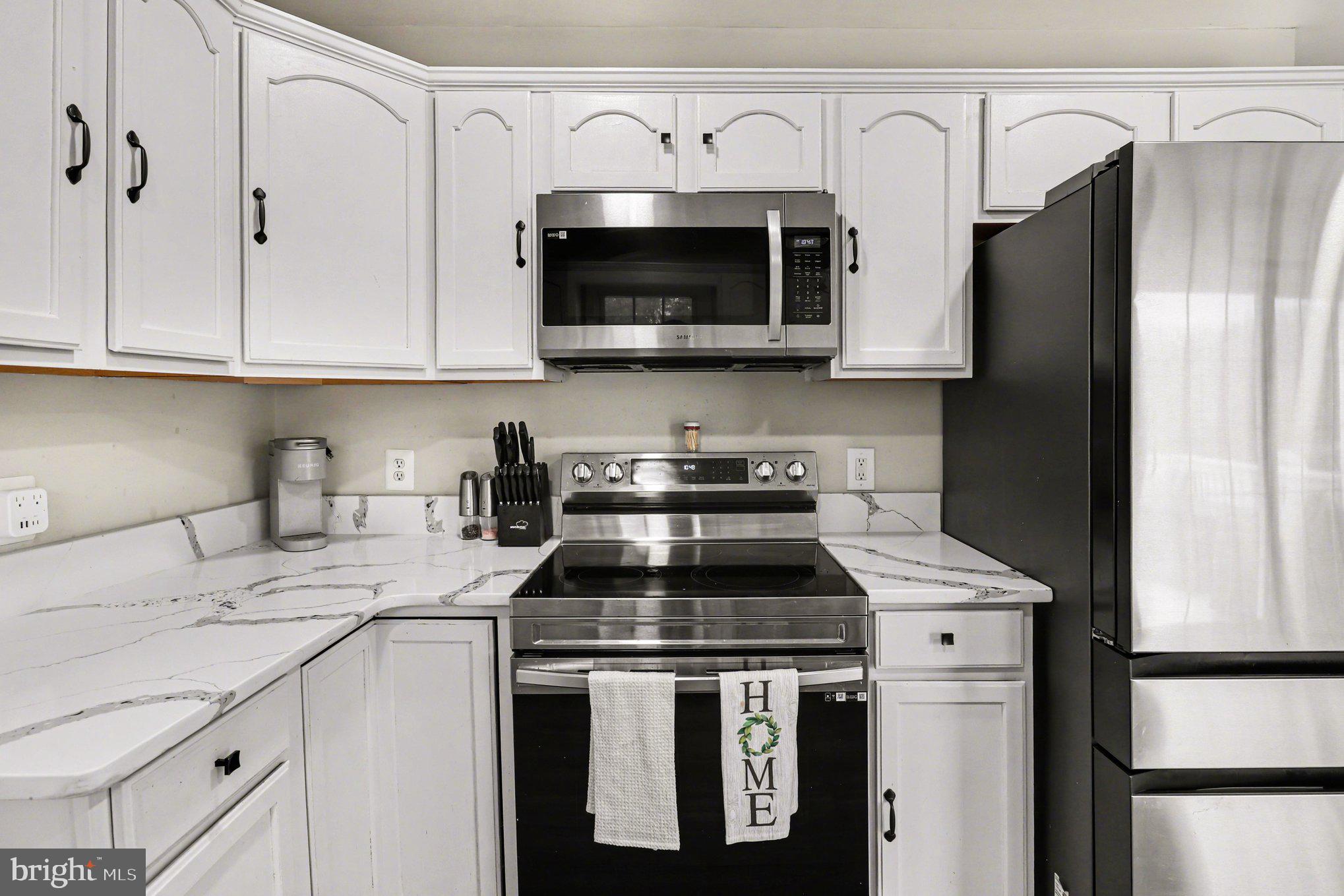 2225 Partlow Road Beaverdam, VA 23015 - Photo 8 of 27 a kitchen with stainless steel appliances granite countertop a sink stove and refrigerator