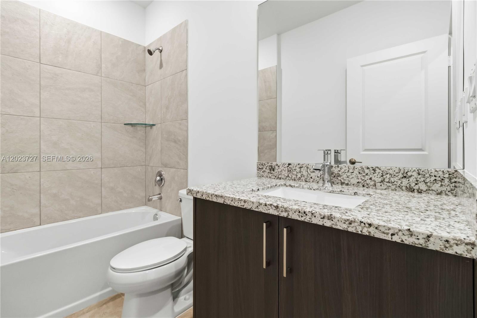 22348 Southwest 115th Court, Unit 22348 Miami, FL 33170 - Photo 33 of 37 a bathroom with a granite countertop sink toilet and shower