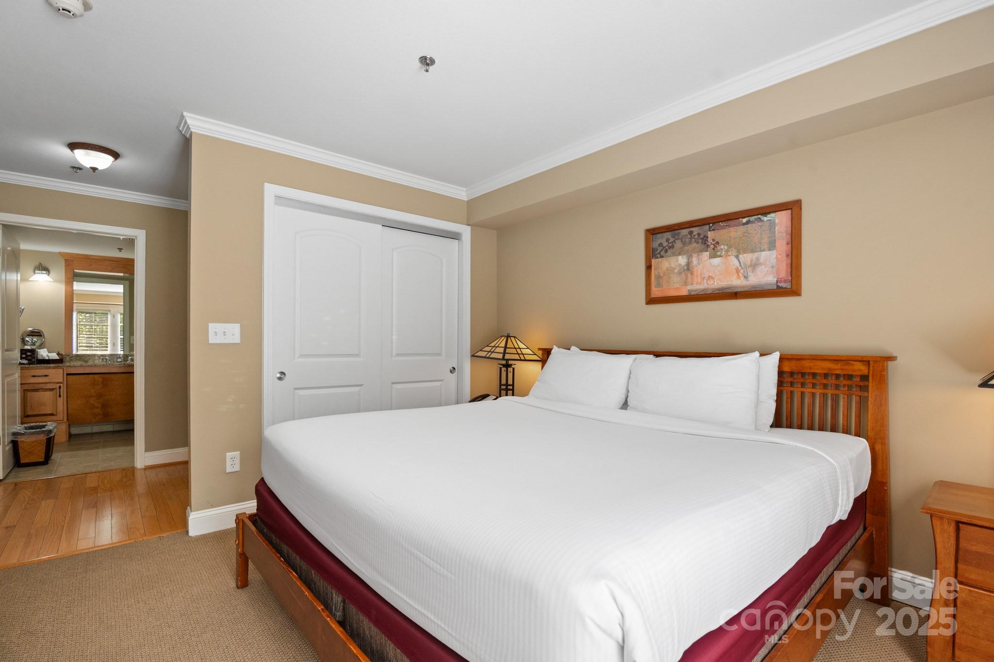 203 Bowling Park Road Asheville, NC 28803 - Photo 11 of 23 a bedroom with a bed and a painting on the wall