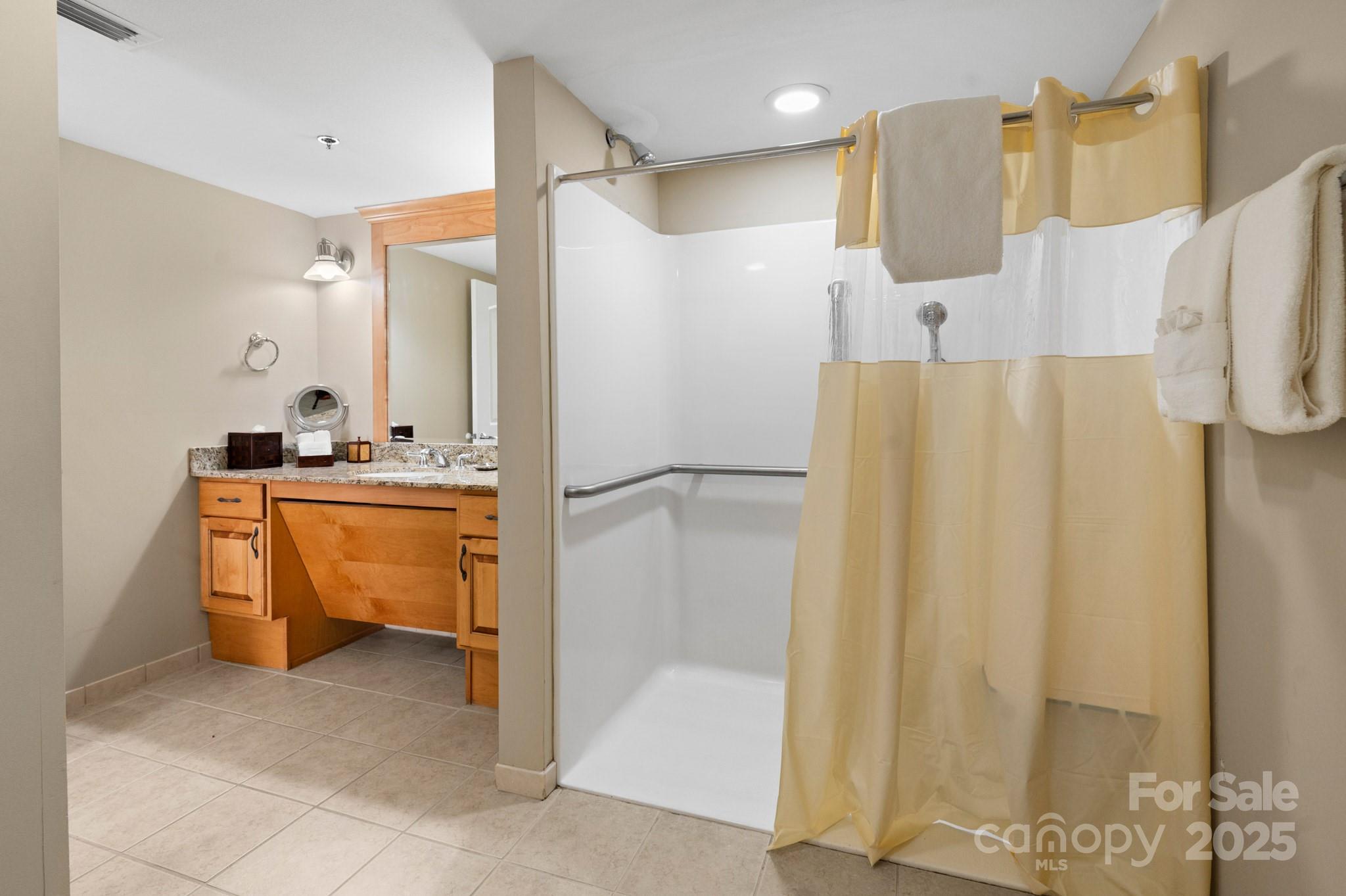 203 Bowling Park Road Asheville, NC 28803 - Photo 13 of 23 a bathroom with a sink mirror and a shower