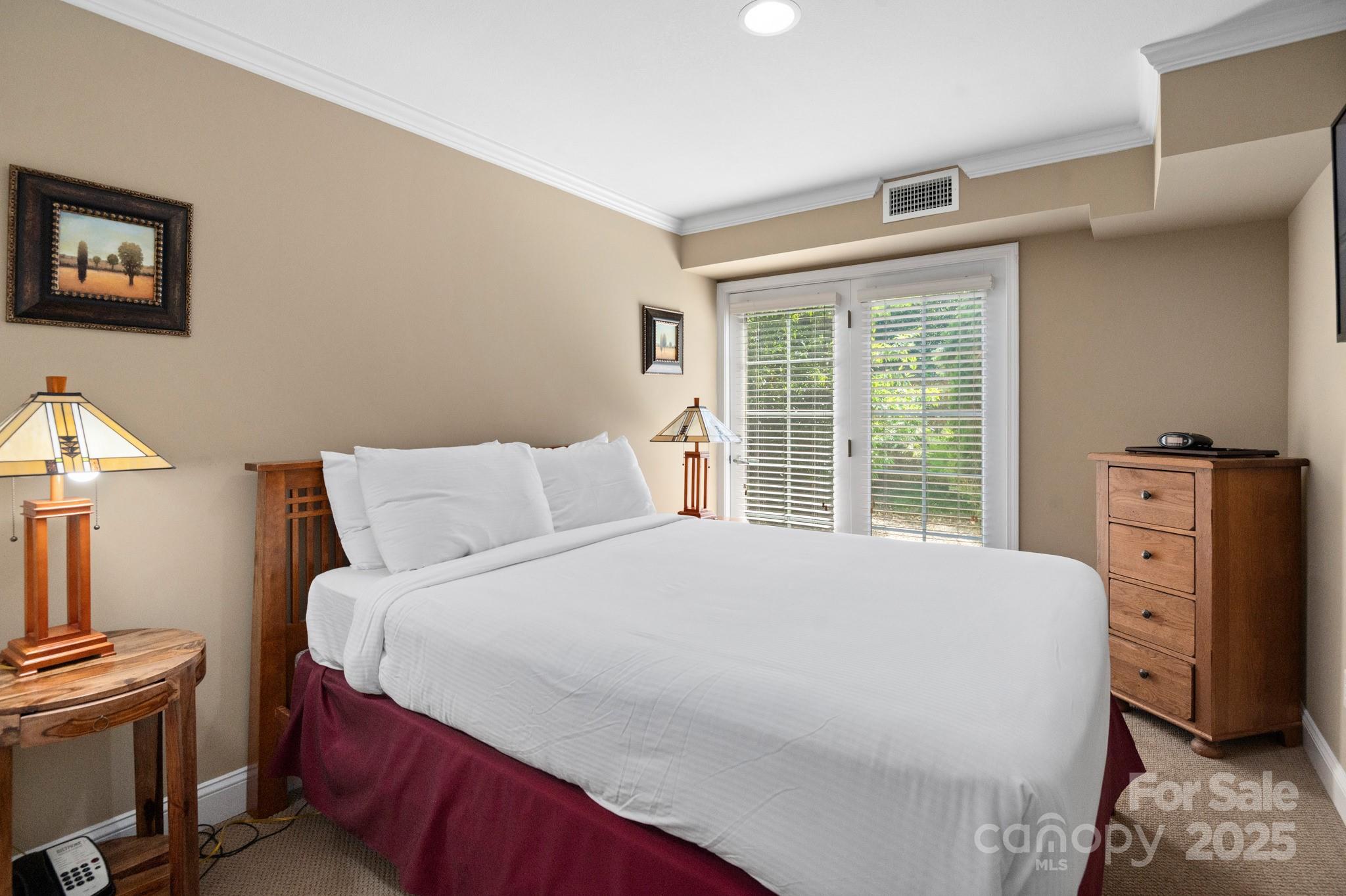 203 Bowling Park Road Asheville, NC 28803 - Photo 14 of 23 a bedroom with a bed and a window