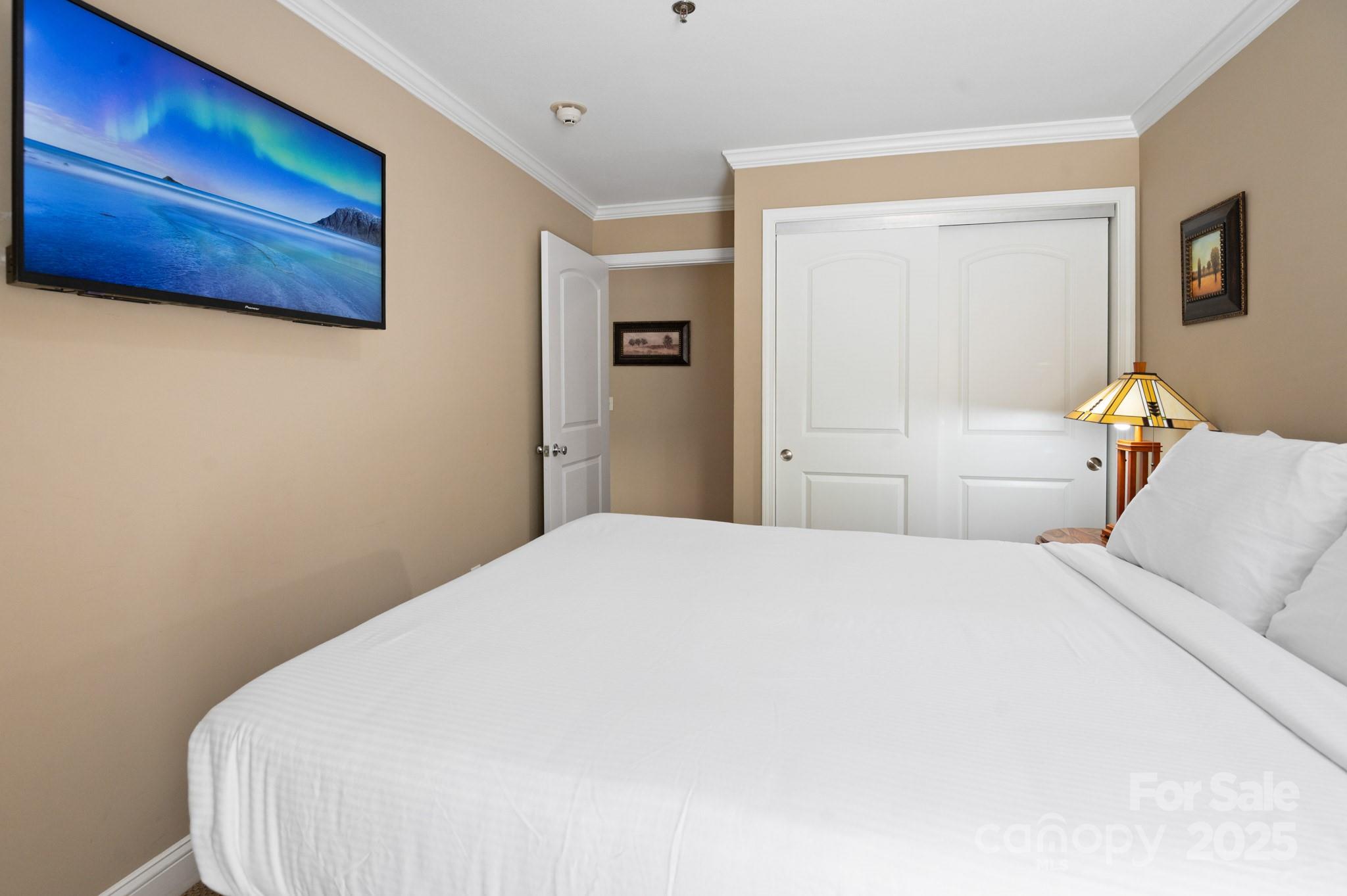203 Bowling Park Road Asheville, NC 28803 - Photo 15 of 23 a bedroom with a bed and wooden floor