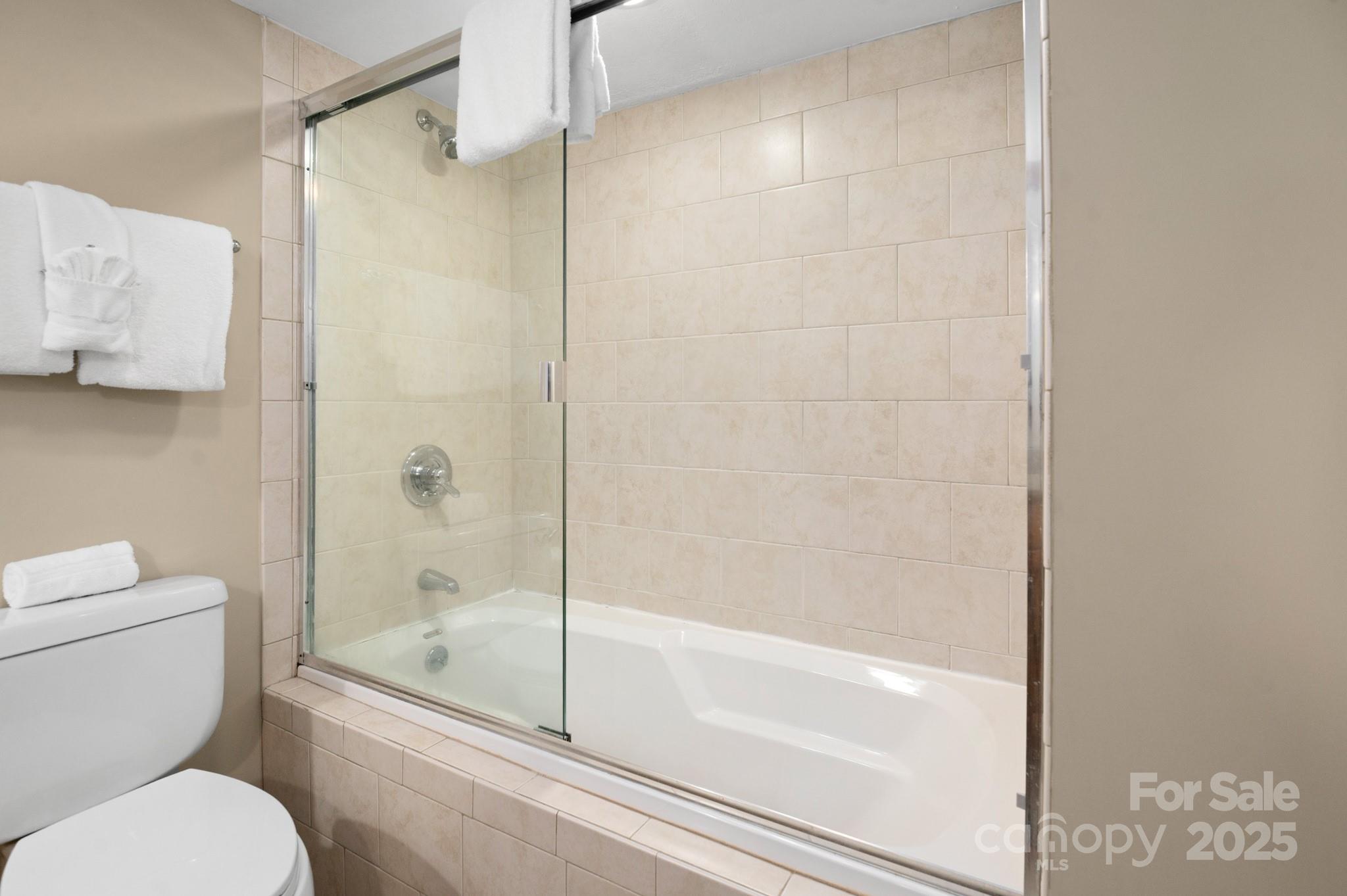 203 Bowling Park Road Asheville, NC 28803 - Photo 17 of 23 a bathroom with a shower and a toilet