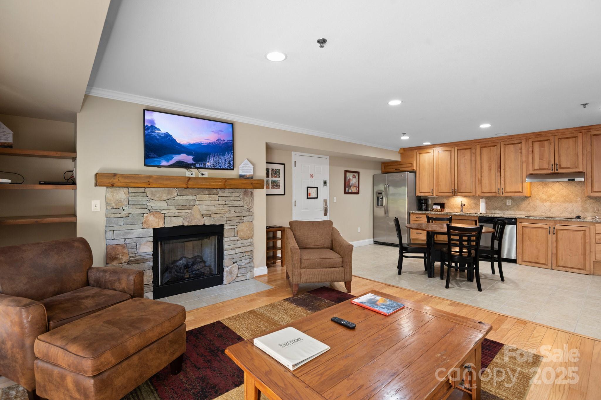 203 Bowling Park Road Asheville, NC 28803 - Photo 7 of 23 a living room with furniture fireplace and kitchen view