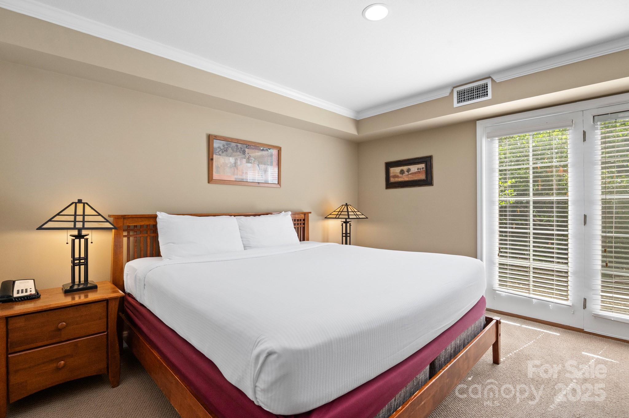 203 Bowling Park Road Asheville, NC 28803 - Photo 10 of 23 a bed sitting in a bedroom next to a window