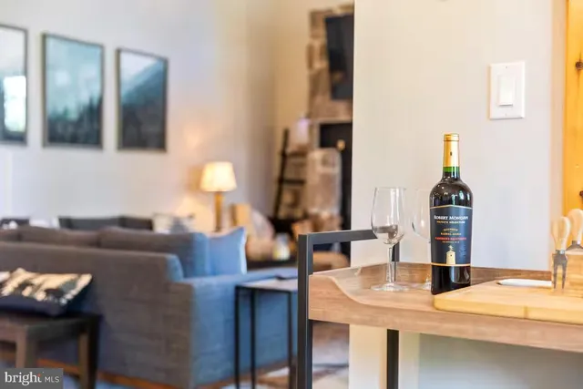 a living room with furniture and a floor to ceiling window