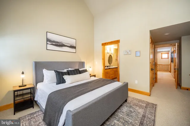 a en suite bathroom with a tub shower and a sink