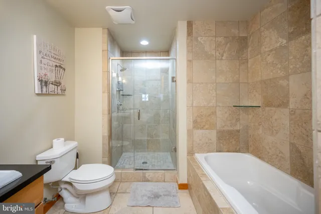 a living room with stainless steel appliances kitchen island granite countertop a sink and cabinets