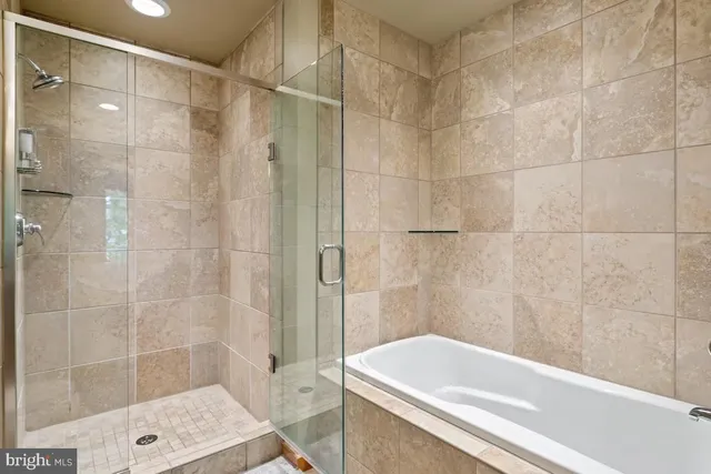 a bedroom with a bed a window and a chandelier