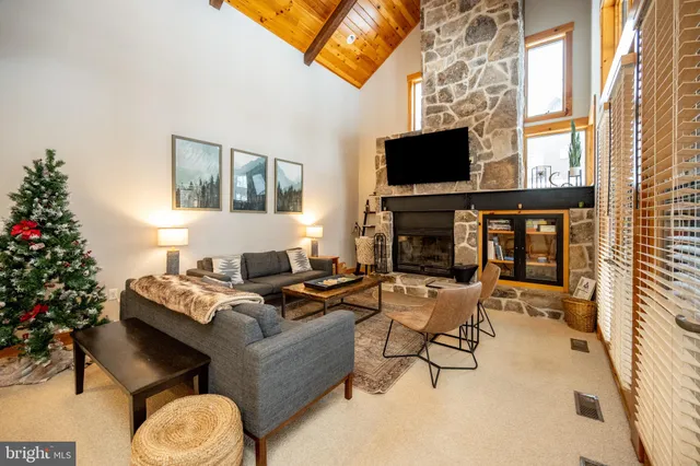 a living room with furniture wooden floor and a fireplace