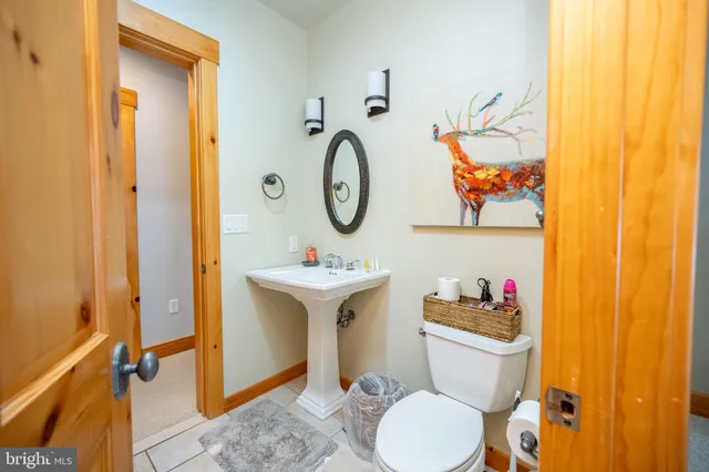 a view of a patio with chairs and floor to ceiling window next to a yard