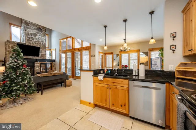 a kitchen with stainless steel appliances granite countertop a refrigerator sink and cabinets