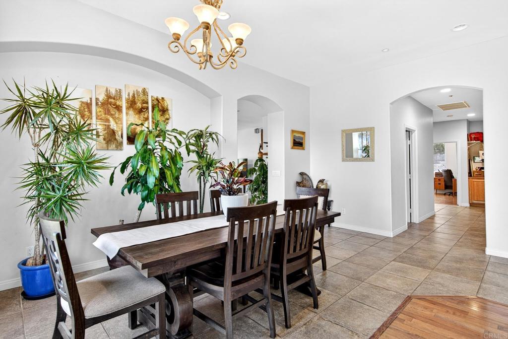 15953 Shalom Road Ramona, CA 92065 - Photo 11 of 71 a view of a dining room with furniture a chandelier and wooden floor