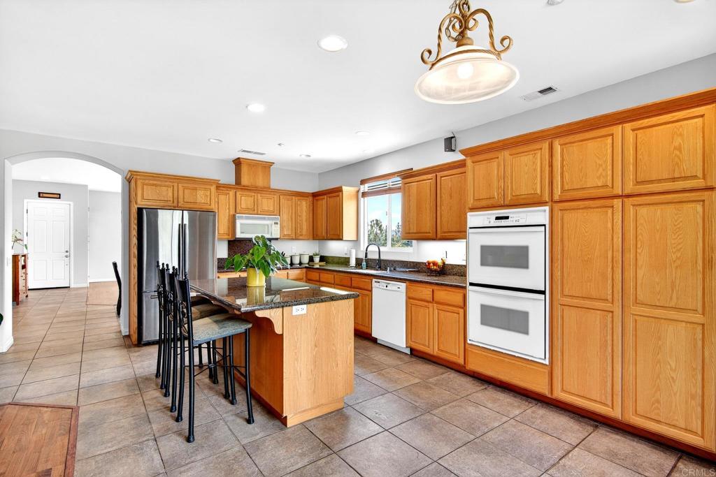 15953 Shalom Road Ramona, CA 92065 - Photo 13 of 71 a kitchen with stainless steel appliances granite countertop a refrigerator sink and stove