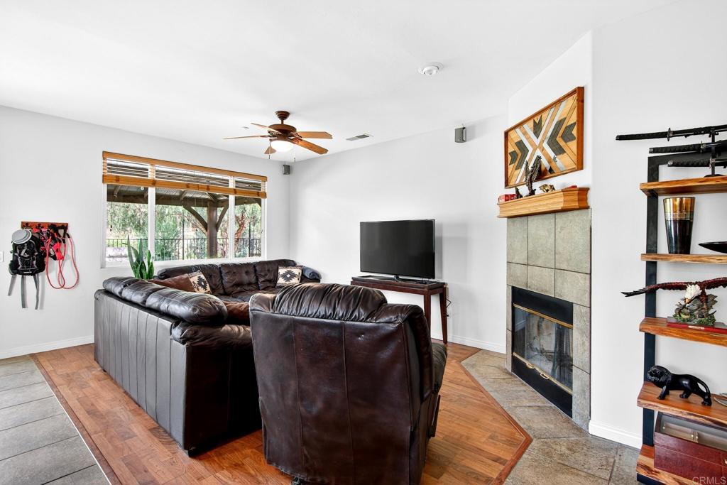 15953 Shalom Road Ramona, CA 92065 - Photo 19 of 71 a living room with furniture a flat screen tv and a fireplace