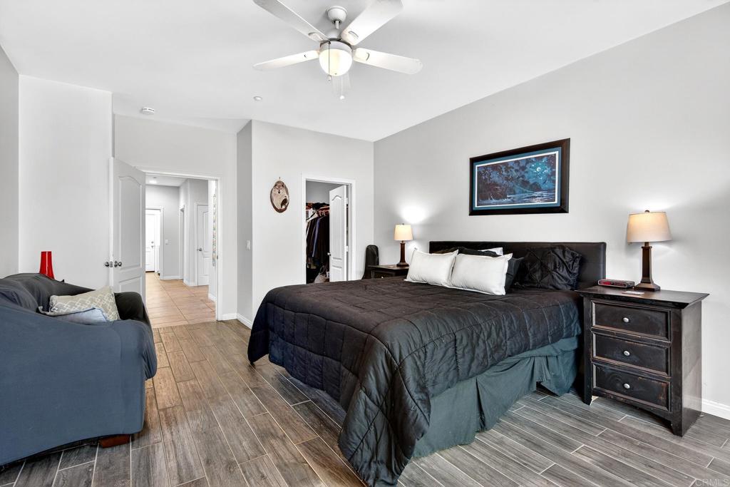 15953 Shalom Road Ramona, CA 92065 - Photo 24 of 71 a bedroom with a bed and a chandelier