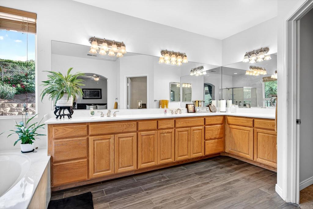 15953 Shalom Road Ramona, CA 92065 - Photo 26 of 71 a spacious bathroom with a granite countertop double vanity and a mirror