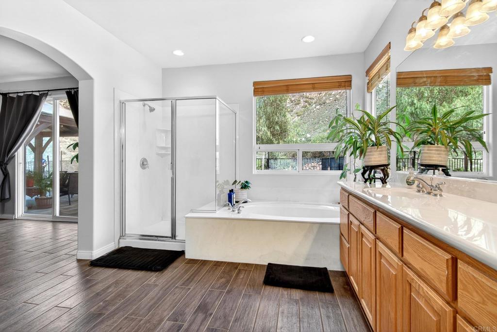 15953 Shalom Road Ramona, CA 92065 - Photo 27 of 71 a bathroom with a large tub a sink and a large window