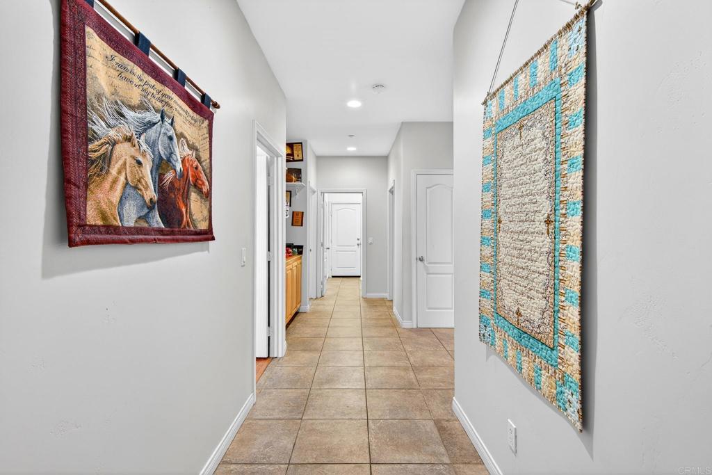 15953 Shalom Road Ramona, CA 92065 - Photo 30 of 71 a view of a hallway with paintings on the wall