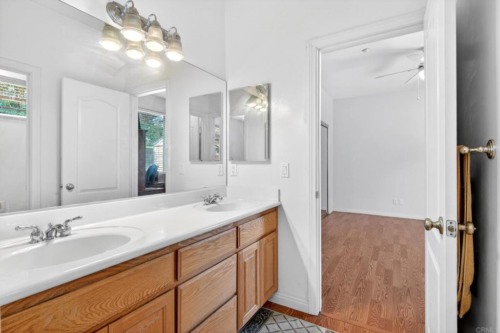 15953 Shalom Road Ramona, CA 92065 - Photo 34 of 71 a bathroom with a double vanity sink and a mirror