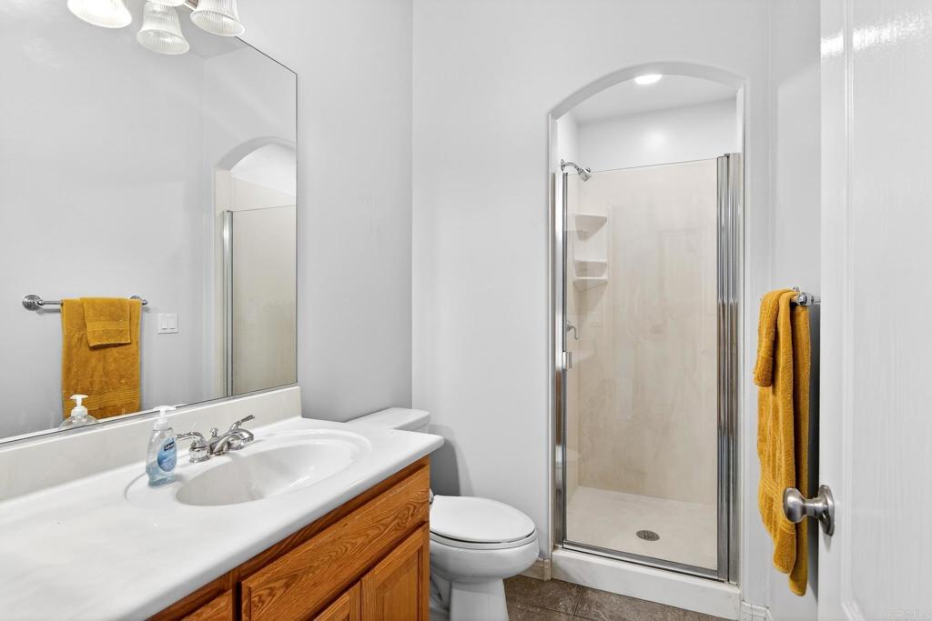 15953 Shalom Road Ramona, CA 92065 - Photo 40 of 71 a bathroom with a granite countertop sink toilet and shower