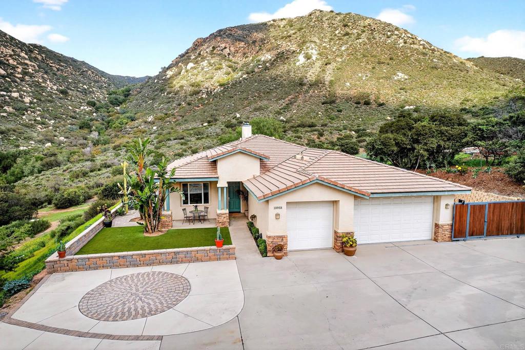 15953 Shalom Road Ramona, CA 92065 - Photo 57 of 71 a aerial view of a house with table and chairs under an umbrella