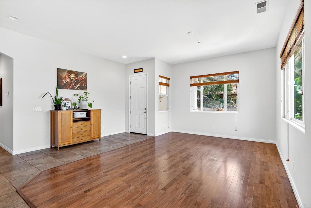 15953 Shalom Road Ramona, CA 92065 - Photo 8 of 71 an empty room with wooden floor and windows