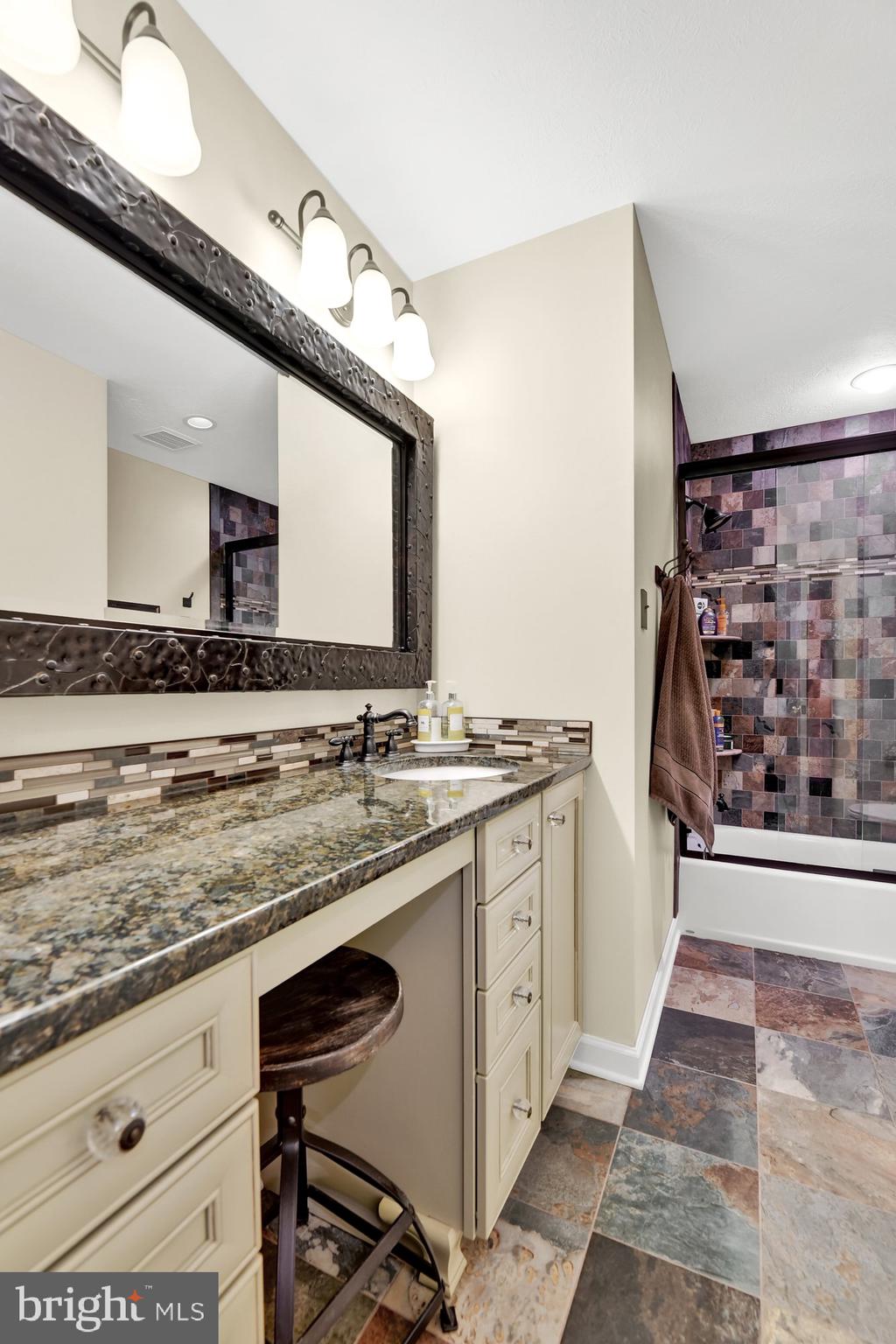 4 Boulder Brook Court Baltimore, MD 21209 - Photo 30 of 49 a bathroom with a granite countertop sink a mirror and shower