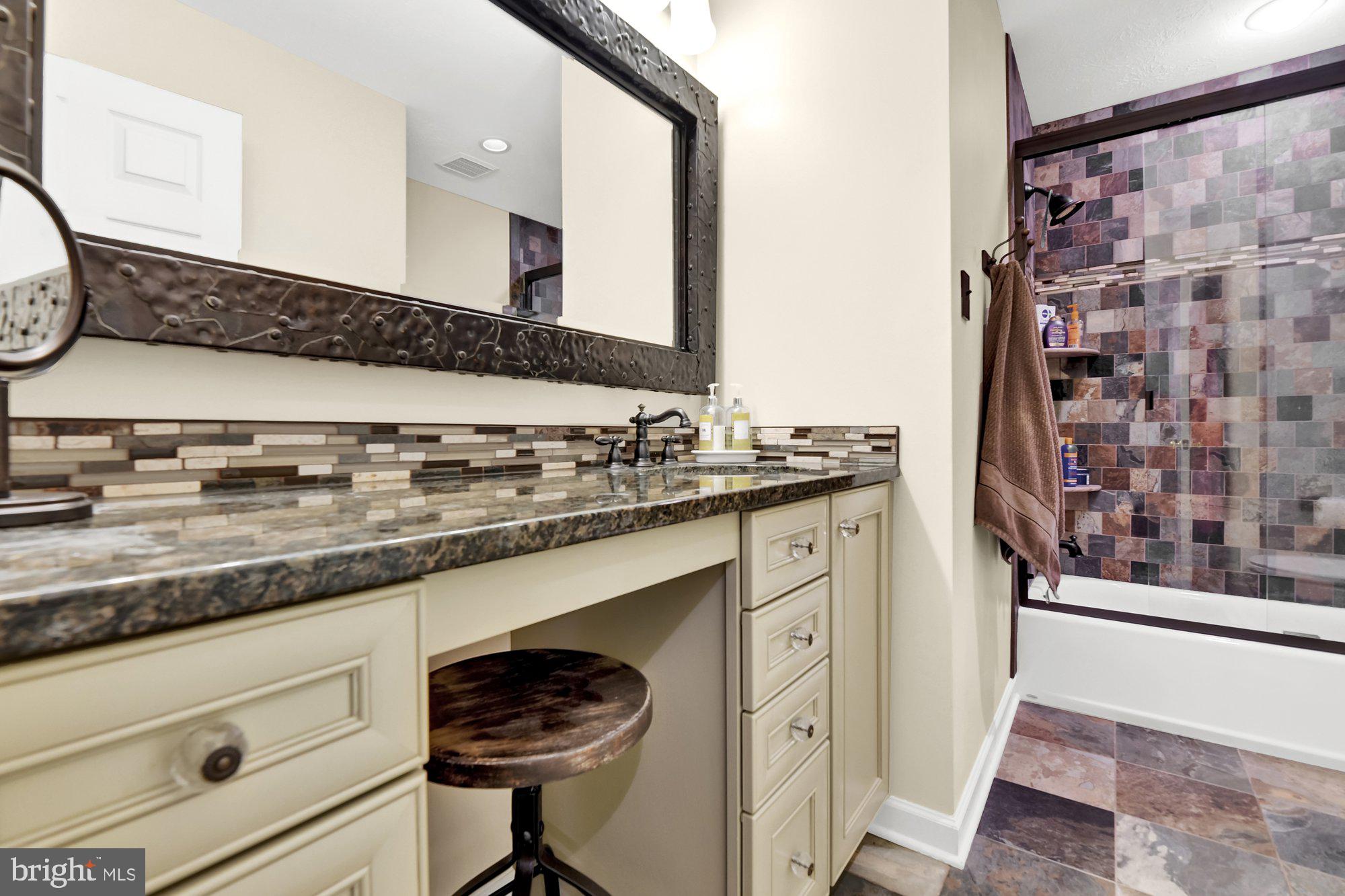 4 Boulder Brook Court Baltimore, MD 21209 - Photo 31 of 49 a bathroom with a granite countertop sink a mirror and shower