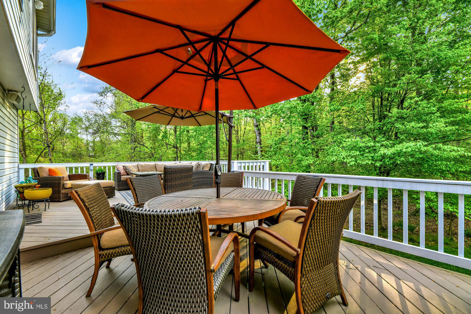 4 Boulder Brook Court Baltimore, MD 21209 - Photo 39 of 49 a patio with wooden floor a yard a table and chairs