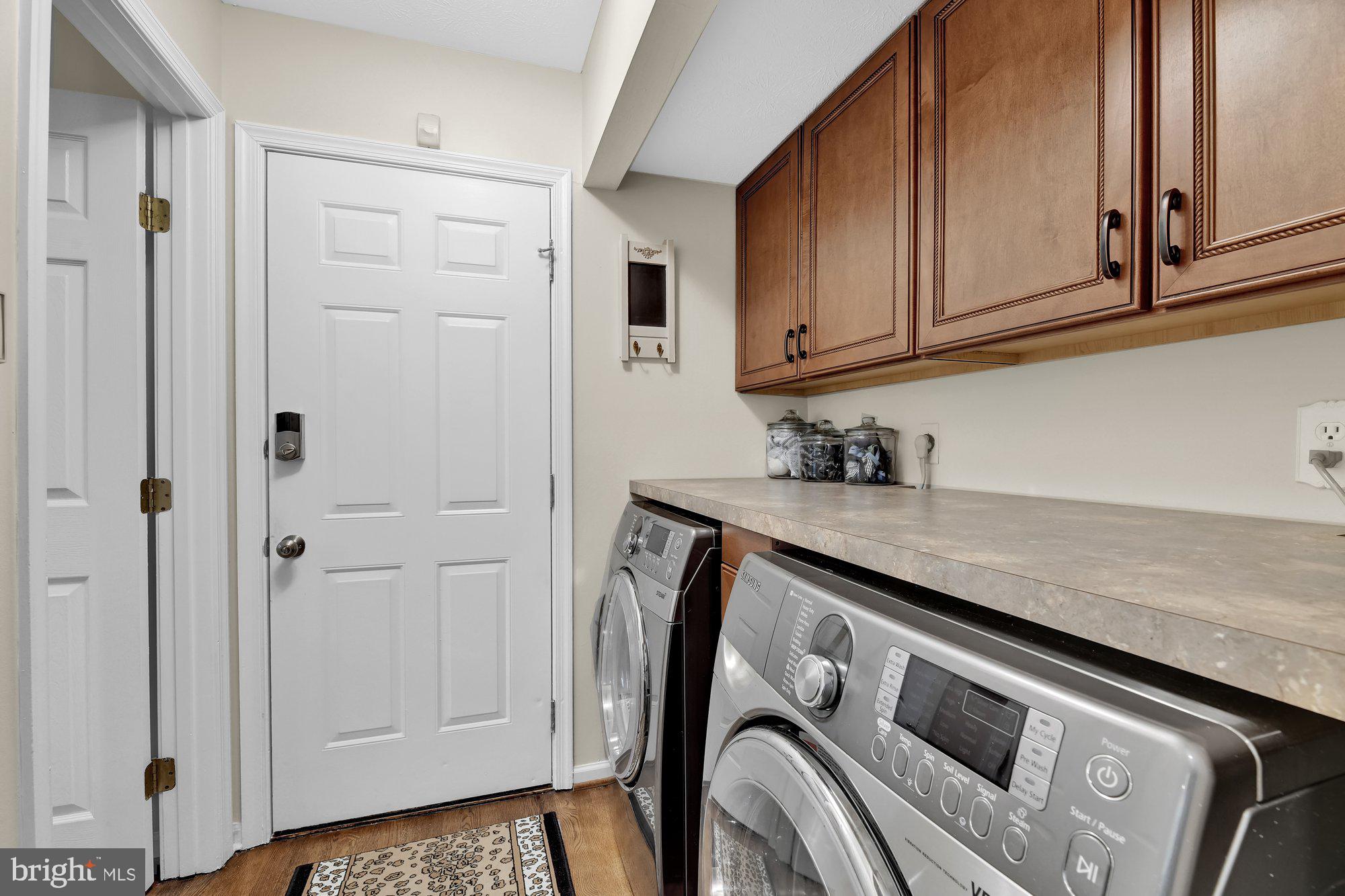 4 Boulder Brook Court Baltimore, MD 21209 - Photo 42 of 49 a utility room with granite countertop cabinets washer and dryer