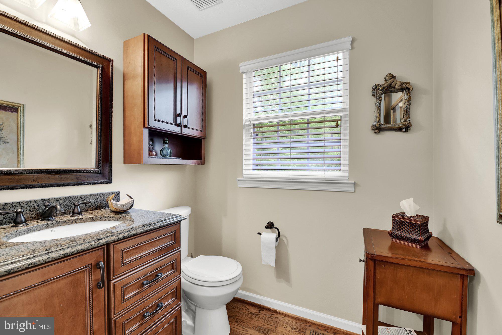 4 Boulder Brook Court Baltimore, MD 21209 - Photo 43 of 49 a bathroom with a granite countertop toilet sink and mirror