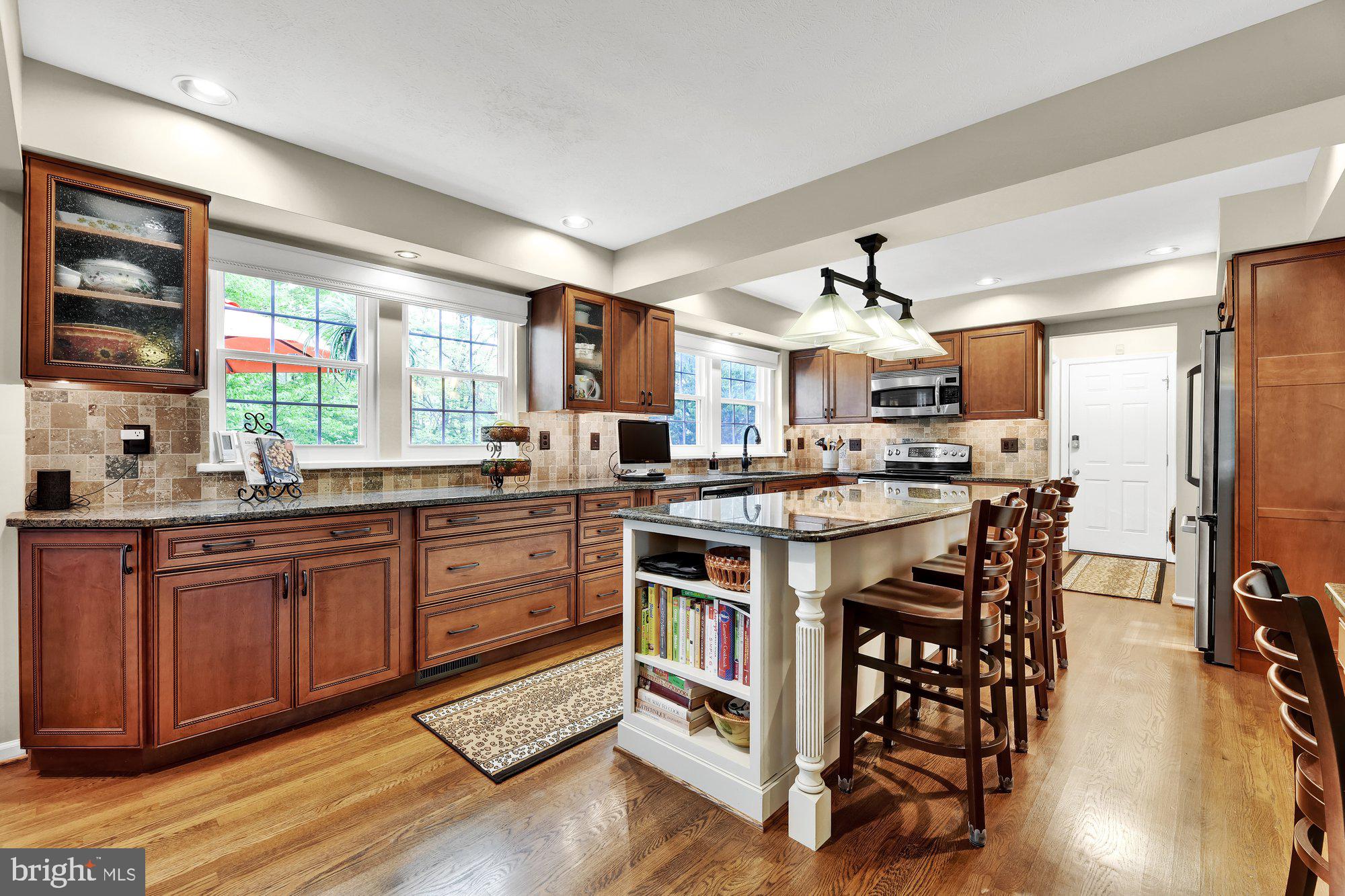 4 Boulder Brook Court Baltimore, MD 21209 - Photo 10 of 49 a kitchen with stainless steel appliances a table and chairs in it