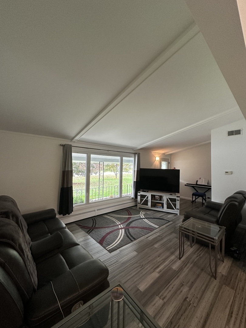 2315 Nan Street Aurora, IL 60502 - Photo 3 of 14 a living room with furniture and a flat screen tv
