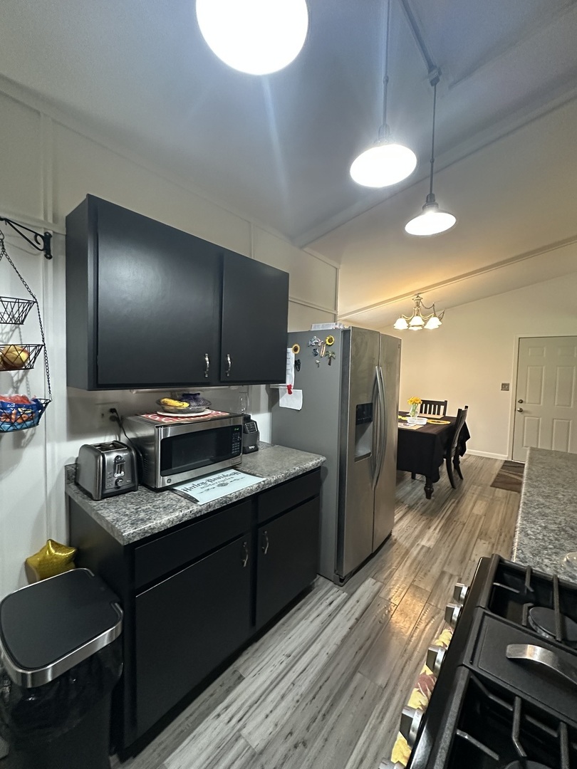 2315 Nan Street Aurora, IL 60502 - Photo 5 of 14 a kitchen with stainless steel appliances granite countertop a refrigerator and a stove