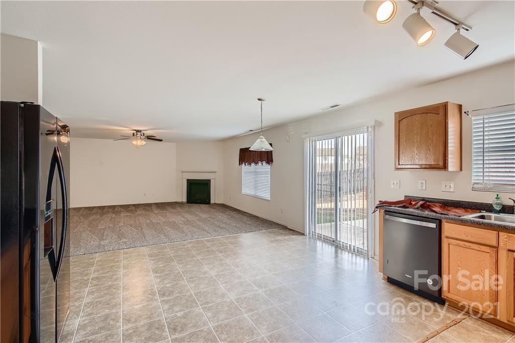 8735 Chalkstone Road Charlotte, NC 28216 - Photo 11 of 29 a kitchen with stainless steel appliances granite countertop a refrigerator a sink dishwasher a stove and a refrigerator with wooden floor