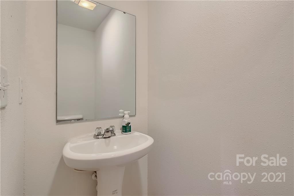 8735 Chalkstone Road Charlotte, NC 28216 - Photo 15 of 29 a bathroom with a sink and a mirror