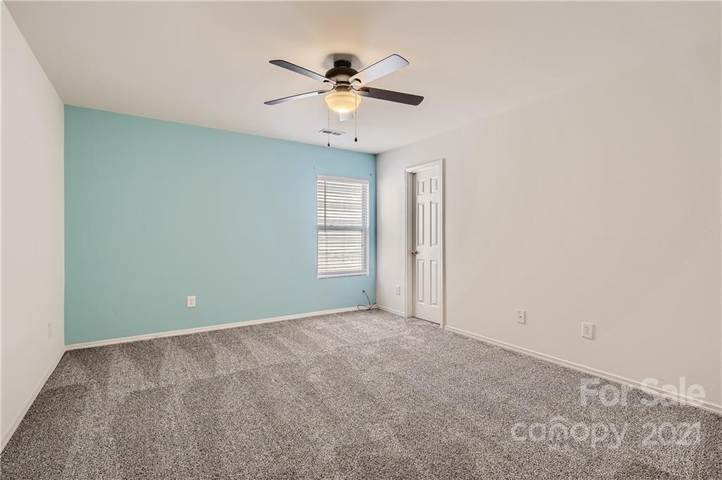 8735 Chalkstone Road Charlotte, NC 28216 - Photo 20 of 29 a view of room with window and ceiling fan