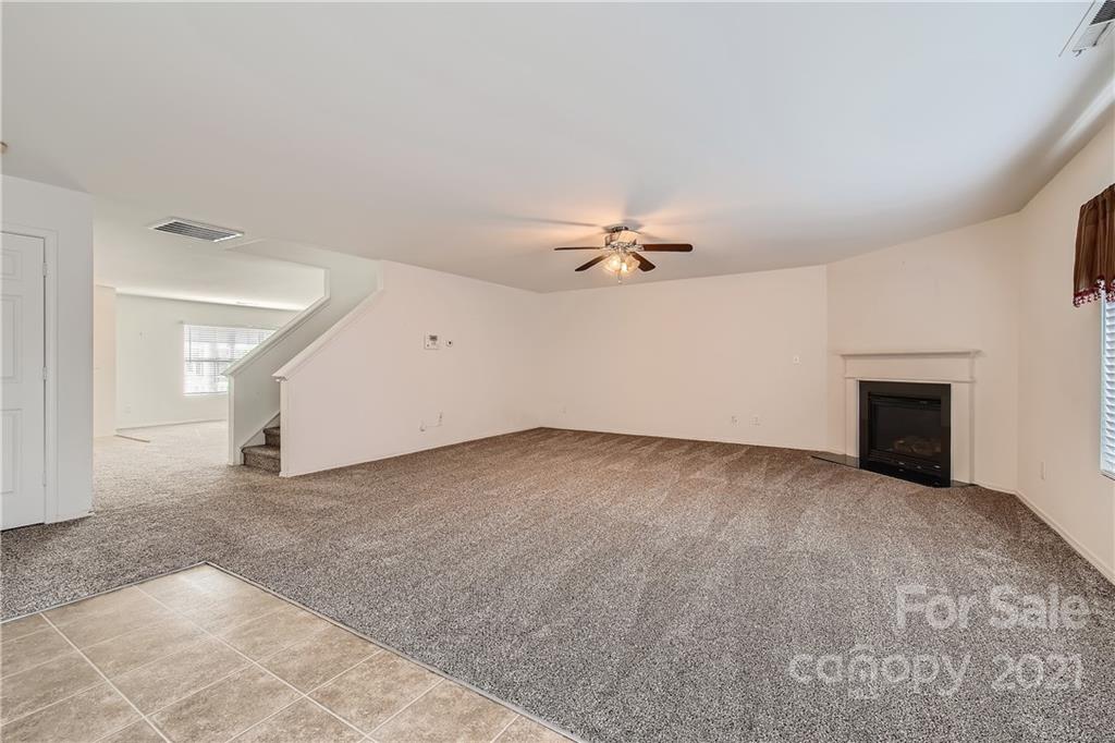 8735 Chalkstone Road Charlotte, NC 28216 - Photo 24 of 29 an empty room with windows and fireplace
