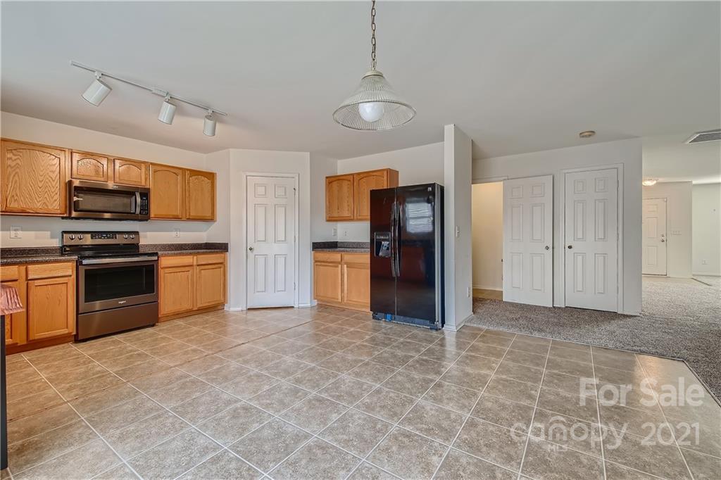 8735 Chalkstone Road Charlotte, NC 28216 - Photo 25 of 29 a kitchen with stainless steel appliances granite countertop a refrigerator and a stove top oven