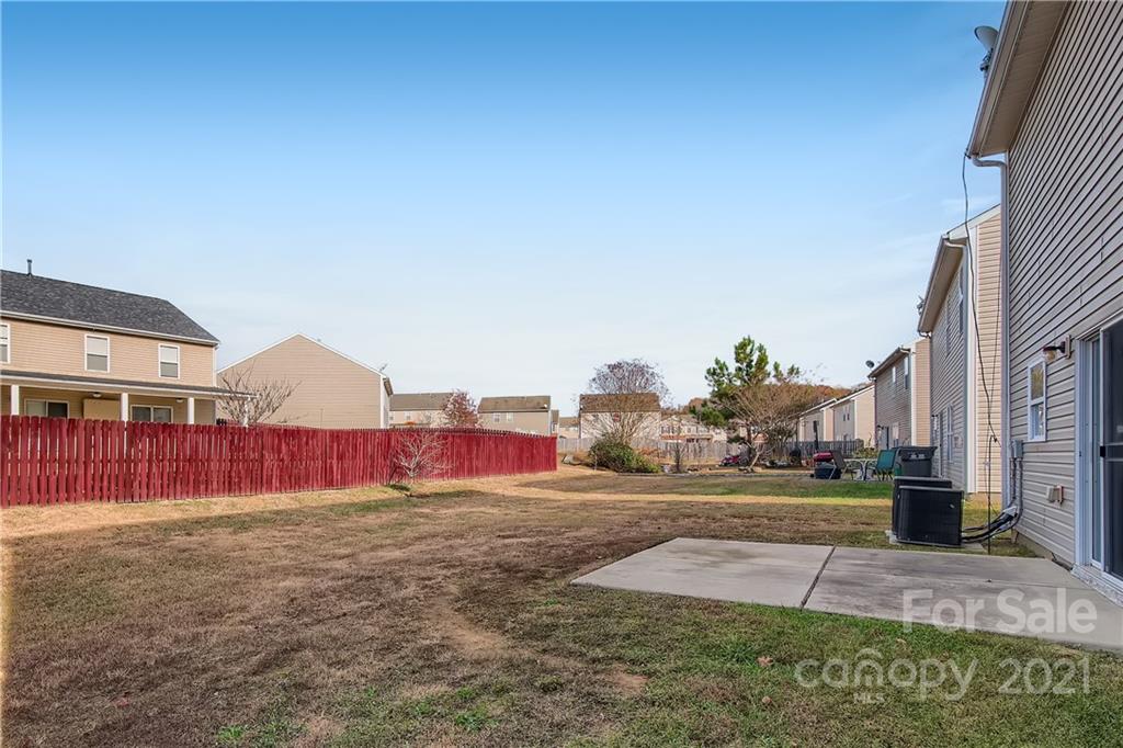 8735 Chalkstone Road Charlotte, NC 28216 - Photo 26 of 29 a view of a yard with cars