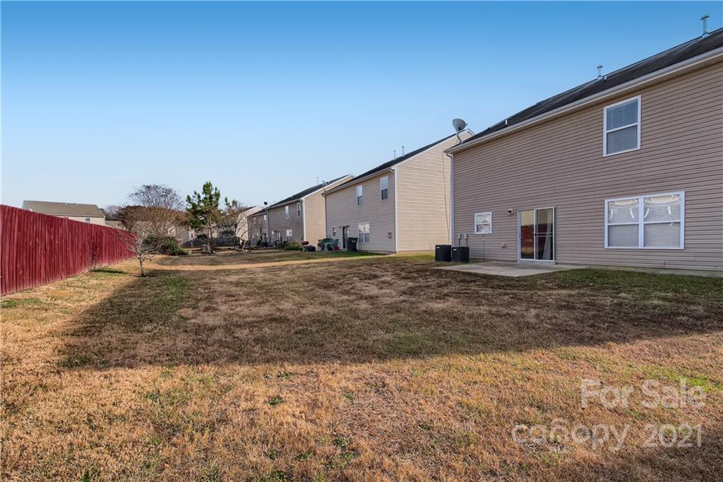 8735 Chalkstone Road Charlotte, NC 28216 - Photo 27 of 29 a view of a house with a yard