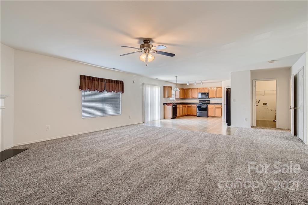 8735 Chalkstone Road Charlotte, NC 28216 - Photo 7 of 29 a view of empty room with a ceiling fan