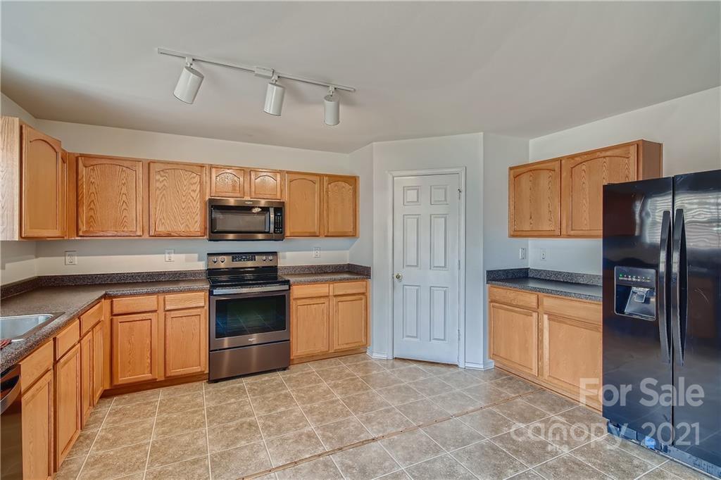 8735 Chalkstone Road Charlotte, NC 28216 - Photo 9 of 29 a kitchen with stainless steel appliances granite countertop a refrigerator and a sink