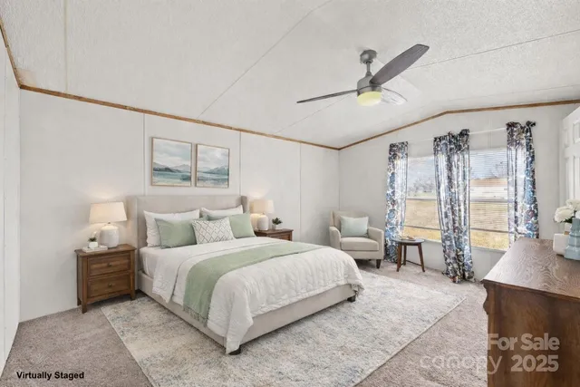 a bedroom with a bed couch and a window