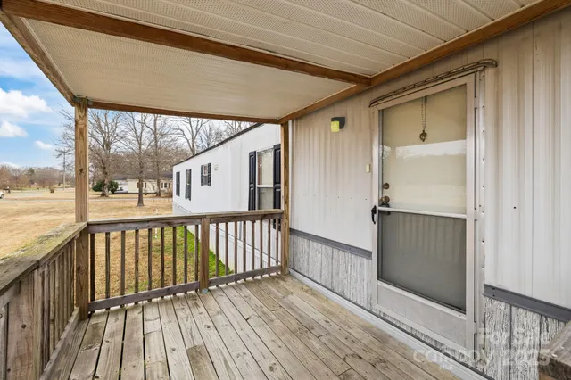 a view of a balcony with wooden floor